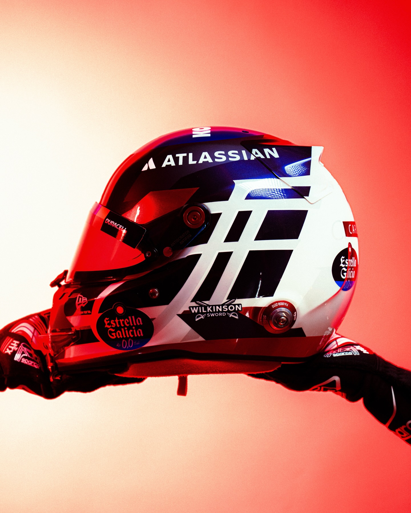 Photo shared by Carlos Sainz on April 30, 2026 tagging @williamsf1official. May be an image of racing vehicles, football helmet, helmet and text.