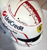 Charles Leclerc's red and egg-white classic Monaco Grand Prix Ferrari helmet (2026) — display/collector reference image (front, Monaco lettering + Ferrari shield)