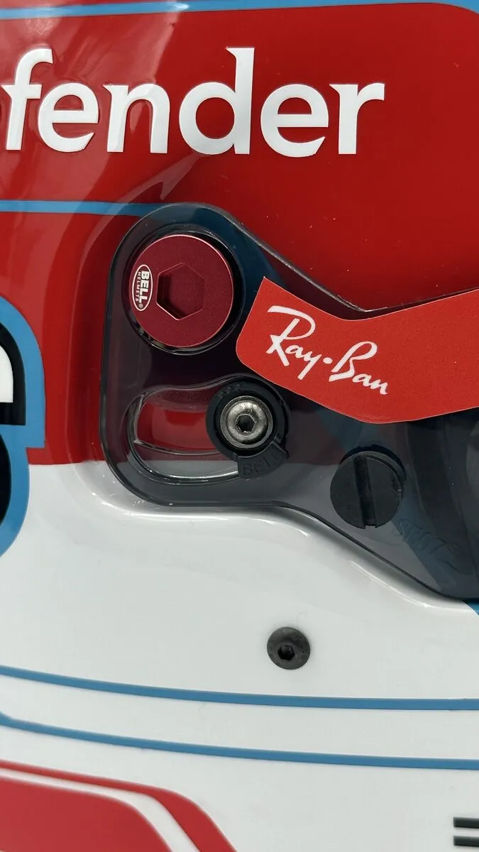 Original visor-pivot hardware and bolt kit on a custom F1 replica display helmet
