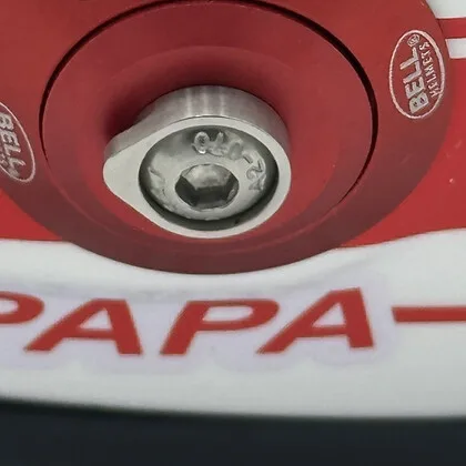Original HANS-post clip and bolt detail on a custom F1 replica display helmet