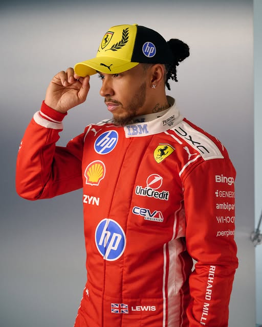 Lewis Hamilton in the red Ferrari race suit with the two-tone yellow cap, 2026 British Grand Prix at Silverstone