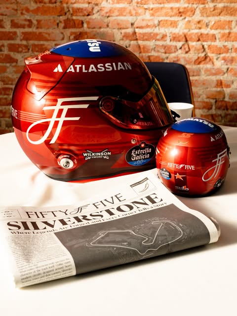 Carlos Sainz 2026 British GP helmet — the silver Fifty Five monogram on the candy-red shell