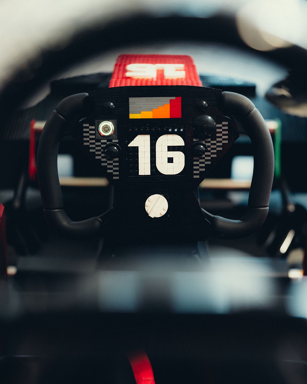 Close-up of the number 16 LEGO steering wheel on Scuderia Ferrari's brick-built kart.