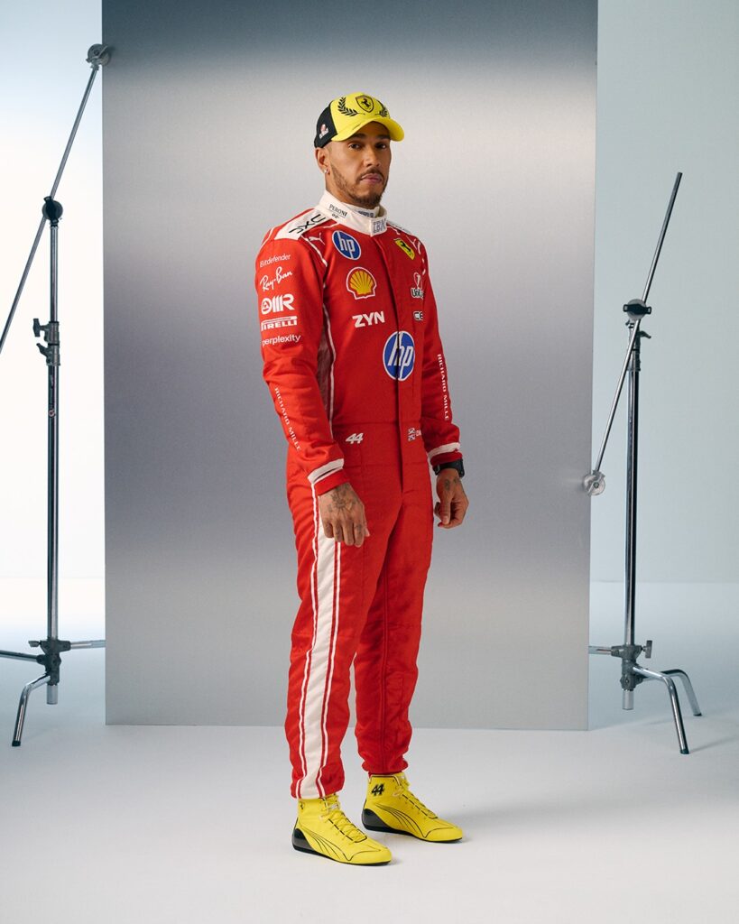 Lewis Hamilton in his red Ferrari race suit with a yellow cap and yellow number 44 boots for the 2026 British Grand Prix at Silverstone.