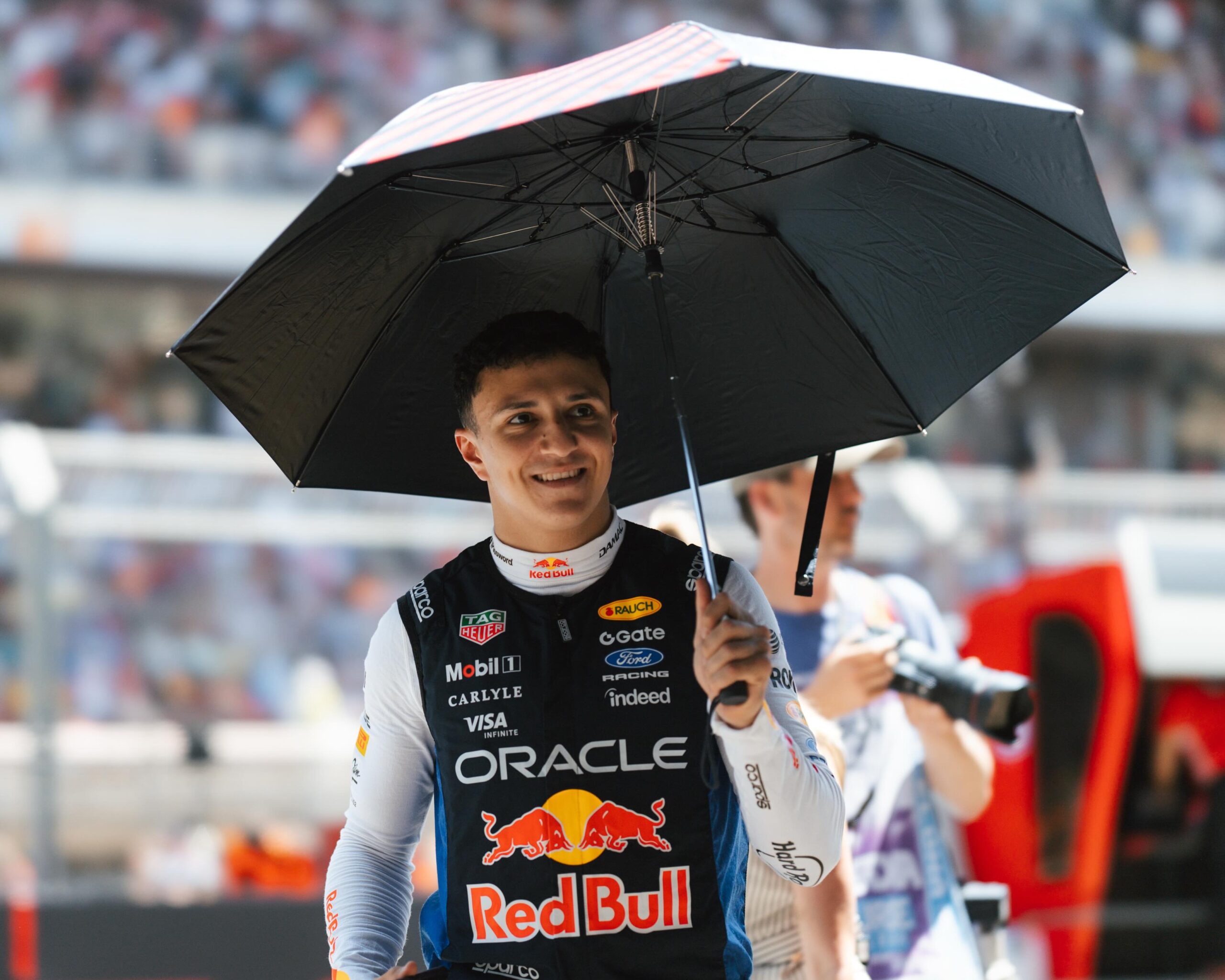 Isack Hadjar in Red Bull Racing colours at Monaco GP, celebrating a recovery drive to sixth place after a difficult start.