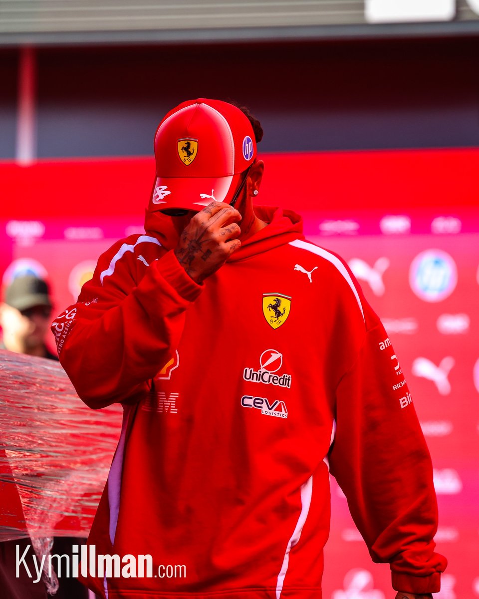 QUIET ARRIVAL Hamilton slipped quietly into the paddock this morning, shielding his face from the cameras as he made hi