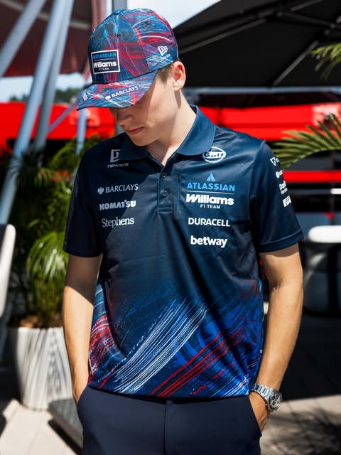 Model wearing the Atlassian Williams Silverstone Race Special navy polo with brushstroke detailing