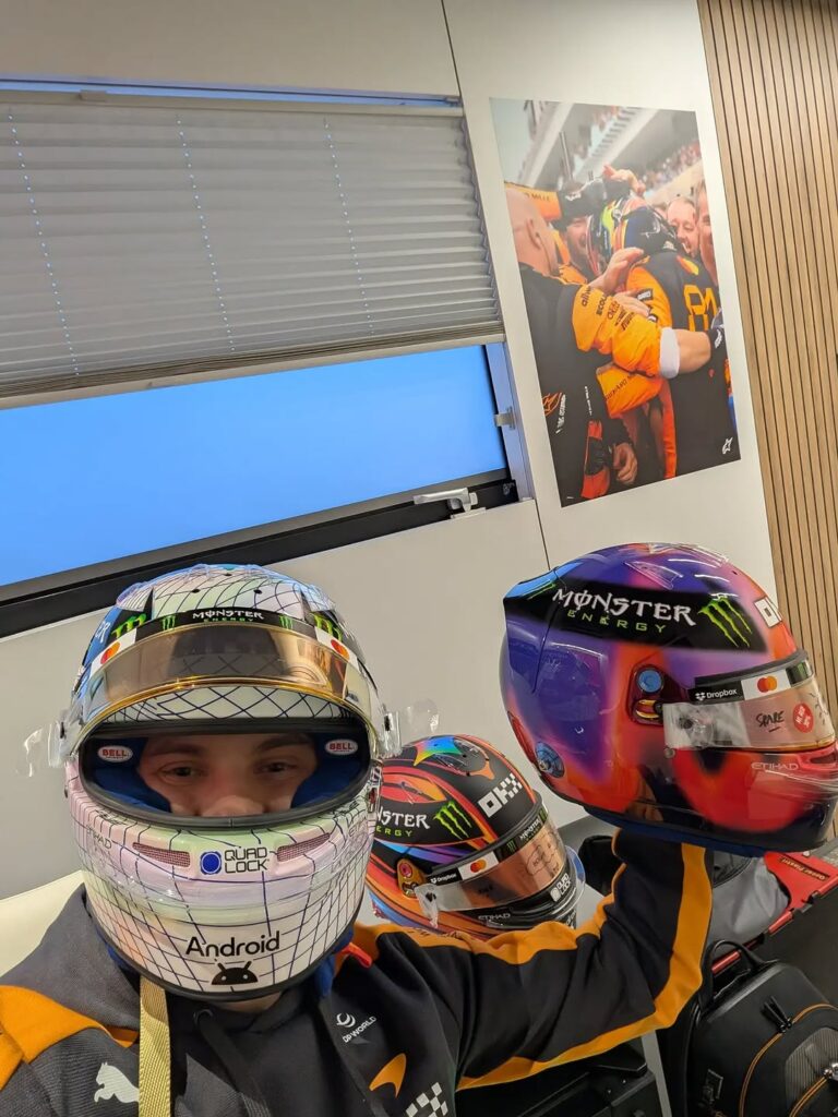 Oscar Piastri with three of his 2026 McLaren helmets