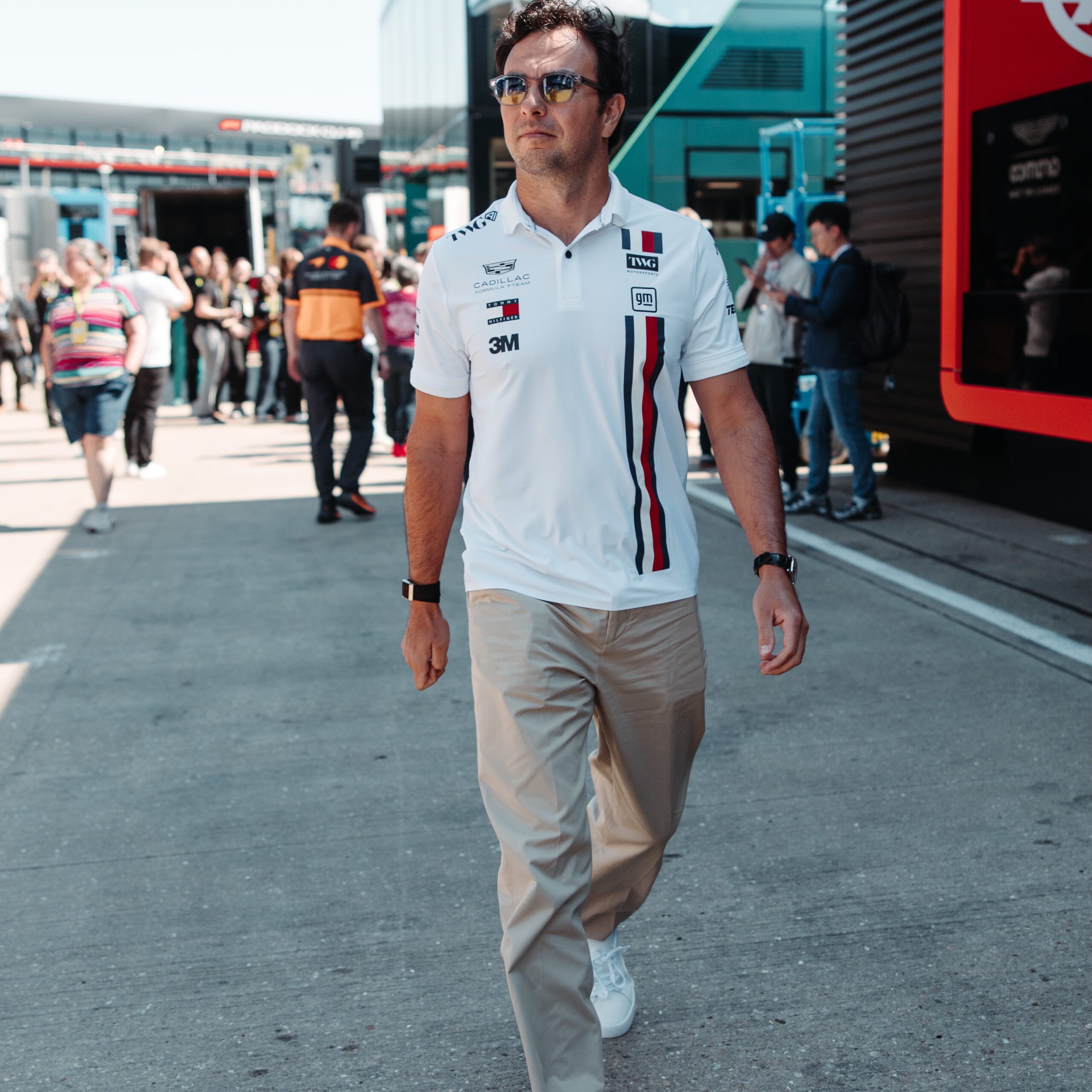 Sergio Perez walks through the Silverstone paddock in Cadillac Formula 1 Team colours in 2026