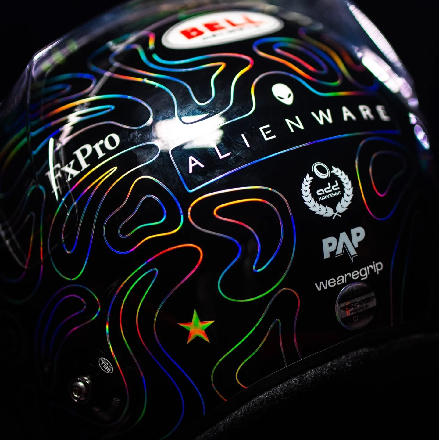 Macro view of the iridescent contour lines and rear sponsor marks on Norris's Dutch GP helmet
