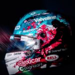 Side view of Fernando Alonso's 2026 Singapore GP helmet: turquoise top, white chin, cherry blossoms and a samurai silhouette
