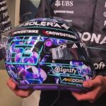 Side view of George Russell's 2026 Singapore GP helmet, black with purple orchids and his number 63 in turquoise outline