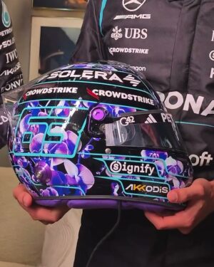 Side view of George Russell's 2026 Singapore GP helmet, black with purple orchids and his number 63 in turquoise outline