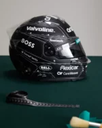 Side view of Fernando Alonso's BOSS x Aston Martin 2026 Spanish GP helmet beside a tailor's tape measure