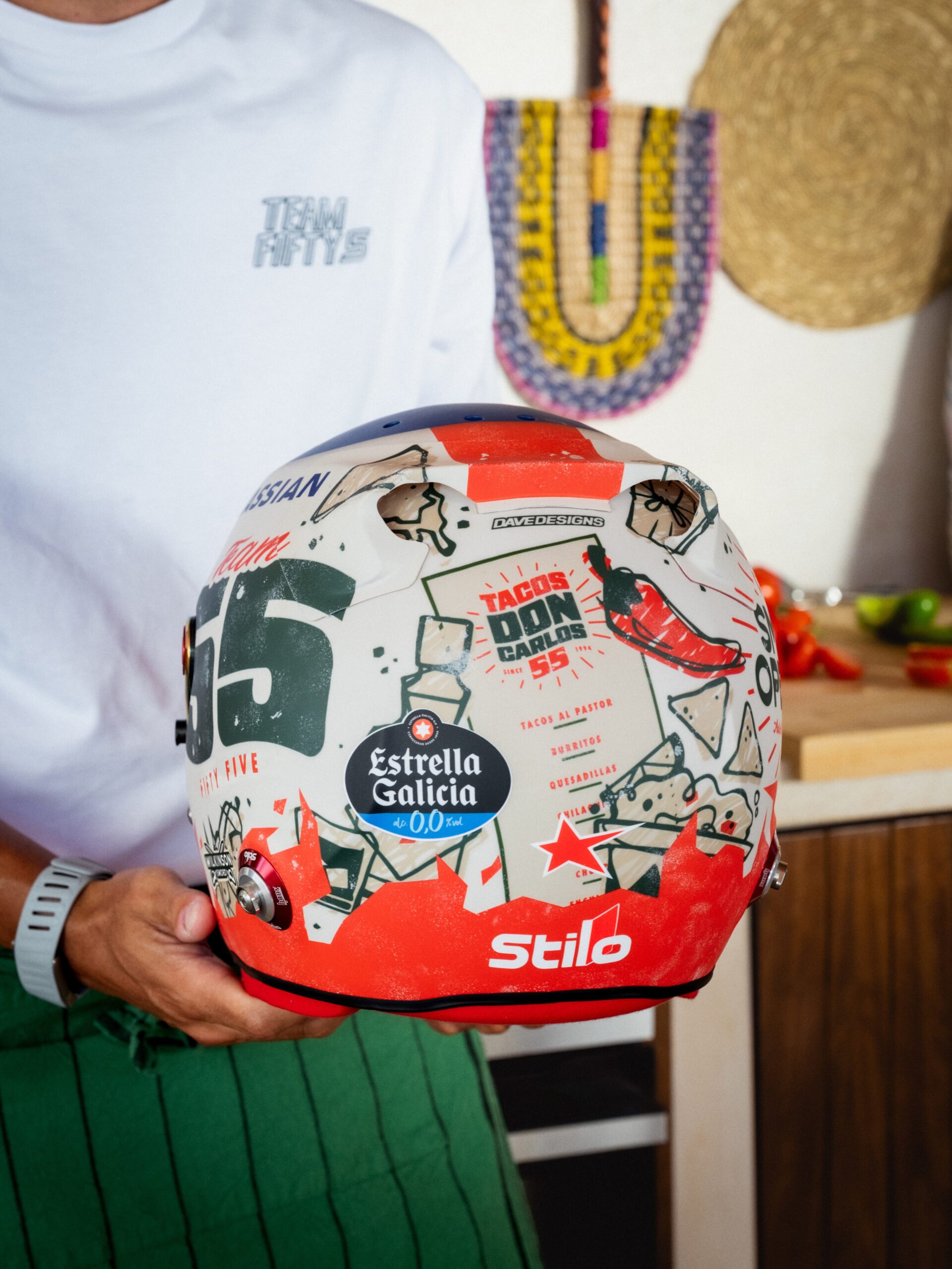 Back of Carlos Sainz's 2026 Mexico City GP helmet, with the Tacos Don Carlos 55 menu, a red chilli and the Stilo logo