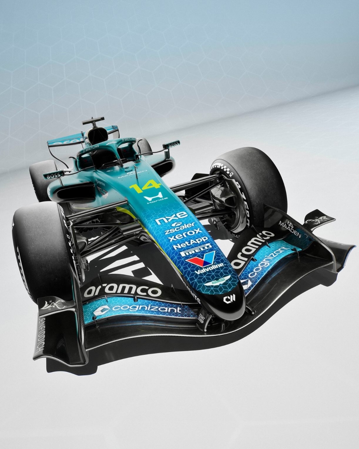 Front three-quarter view of Aston Martin's Cognizant livery with the blue hexagonal pattern on the nose and front wing