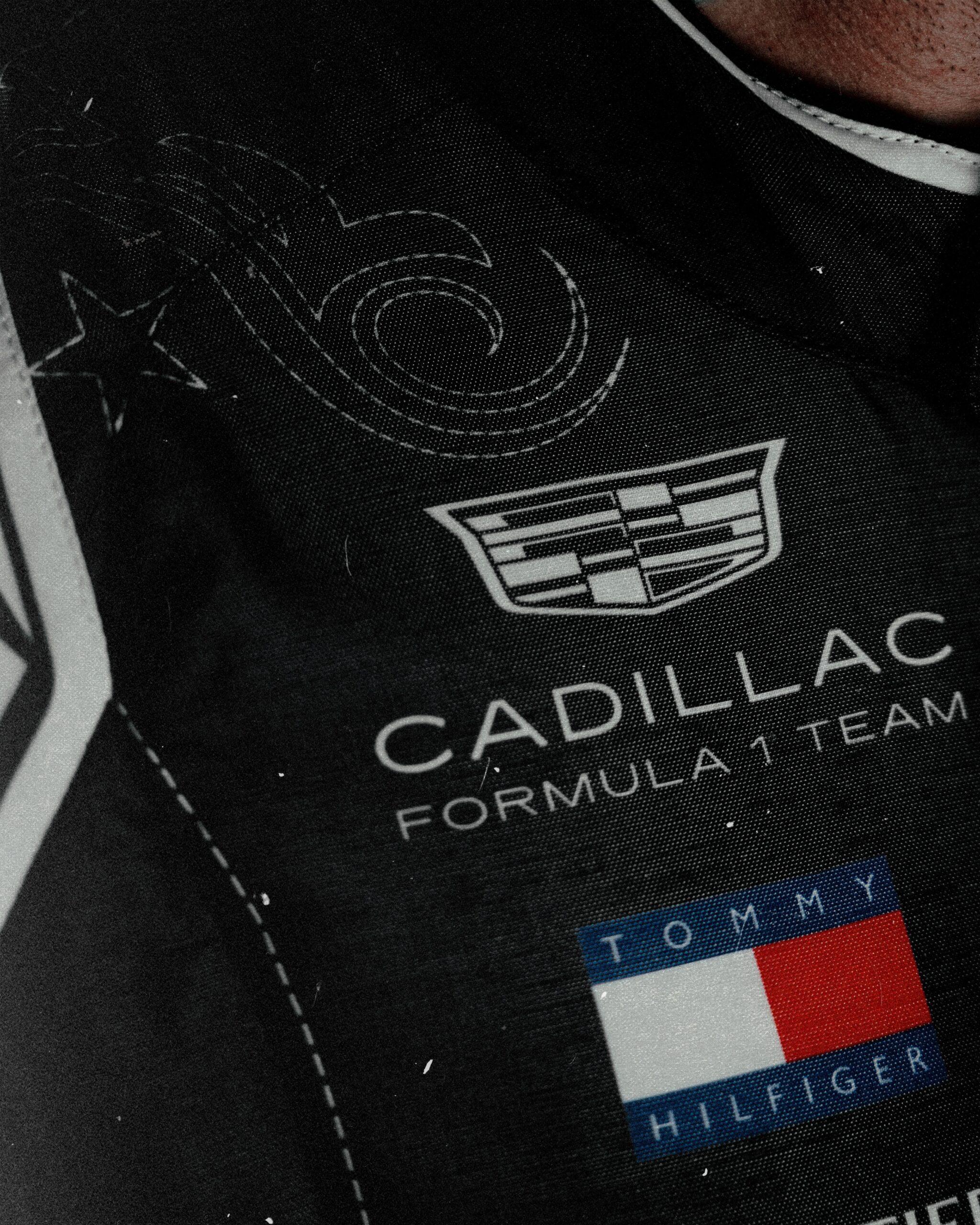 Cadillac crest and Tommy Hilfiger flag on the stitched black chest panel of the Austin race suit