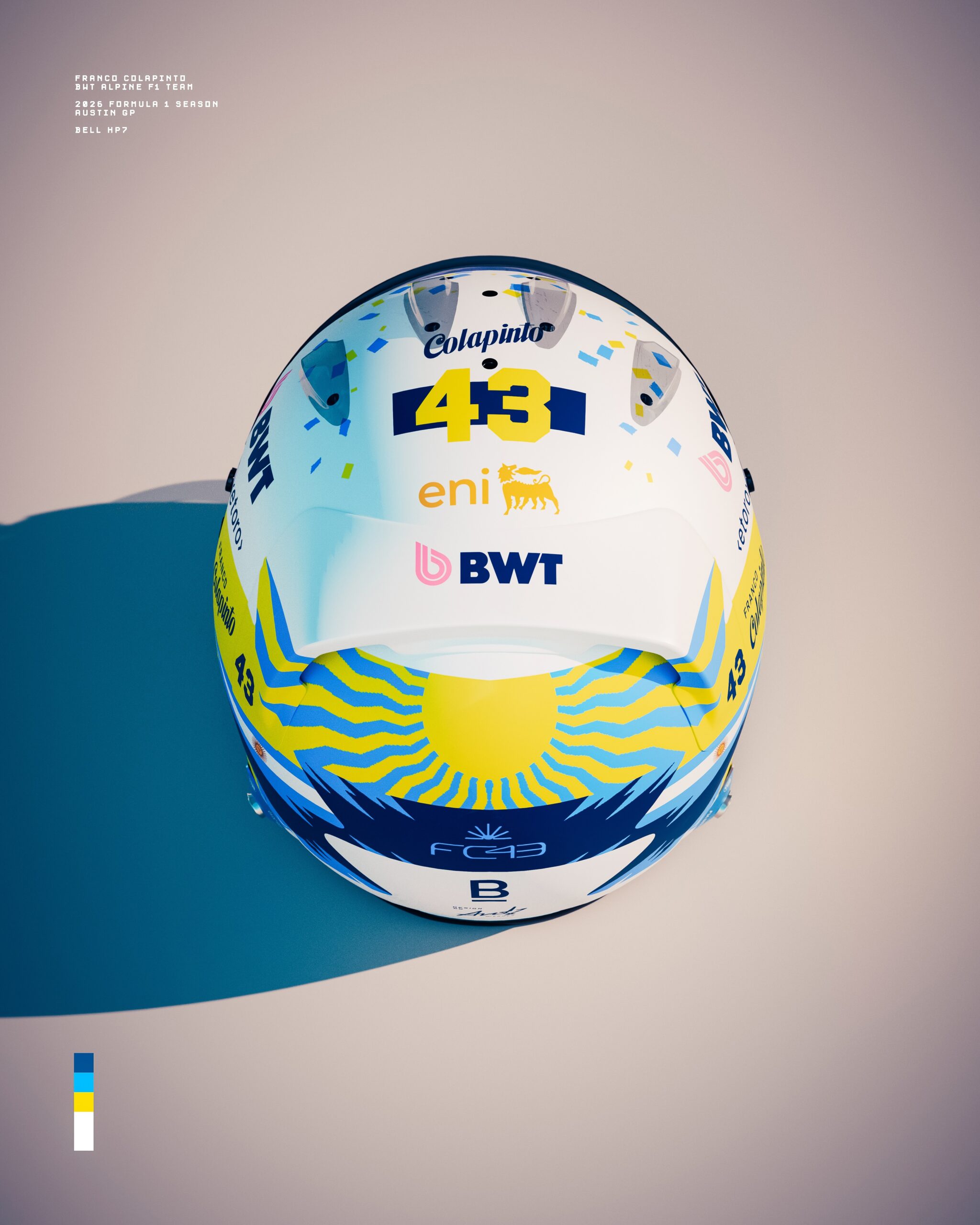 Top of Colapinto's Austin 2026 helmet: blue, yellow and white confetti-like squares, Colapinto 43 on a navy band