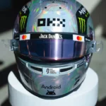 Front view of Lando Norris's iridescent silver 2026 US GP helmet with the OKX and Jack Daniel's logos