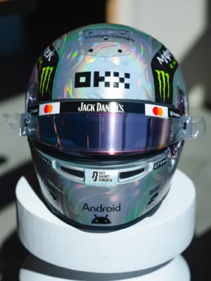 Front view of Lando Norris's iridescent silver 2026 US GP helmet with the OKX and Jack Daniel's logos