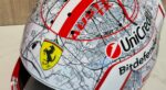Painted crown of Charles Leclerc's Austin 2026 helmet: AUSTIN TX in red, #JB17 on the street map, Ferrari shield, UniCredit and Bitdefender
