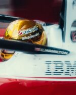 Side of Lewis Hamilton's gold chrome 2026 Singapore GP helmet in the Ferrari SF-26 cockpit, UniCredit and Bitdefender
