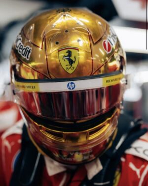 Front of Lewis Hamilton's gold chrome 2026 Singapore GP helmet: Ferrari crest above the visor, Richard Mille and HP on the visor strip
