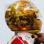 Side profile of Lewis Hamilton's gold chrome 2026 Singapore GP helmet: UniCredit, Bitdefender, 44 and HAM