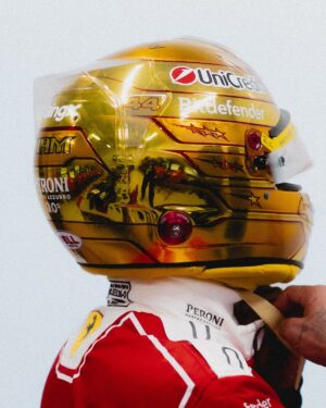 Side profile of Lewis Hamilton's gold chrome 2026 Singapore GP helmet: UniCredit, Bitdefender, 44 and HAM