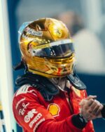 Lewis Hamilton wearing his gold chrome 2026 Singapore GP helmet, seen from the front three-quarter