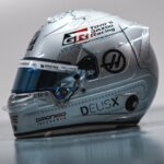 Side view of Oliver Bearman's 2026 Singapore GP helmet, glitter silver with holographic lines, Toyota Gazoo Racing and Haas logos